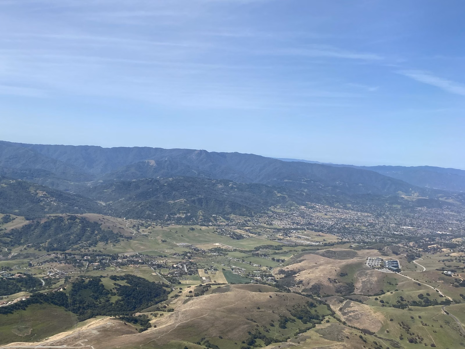 View across the ridges and valleys of the Santa Cruz Mountains under a blue sky